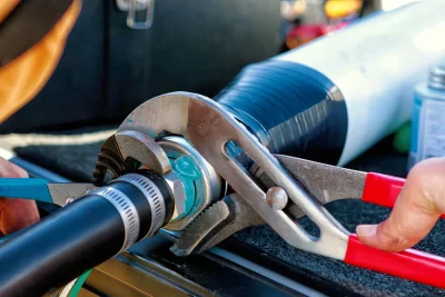 Technician tightening an industrial pipe connection in Palm Beach Gardens