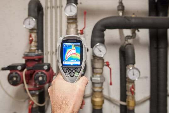 Plumber using a thermal imaging camera to inspect pipes in Palm Beach Gardens