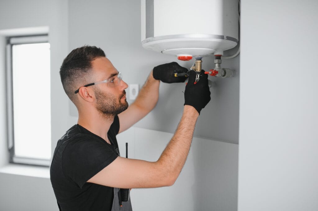 Technician performing water heater maintenance in Palm Beach Gardens